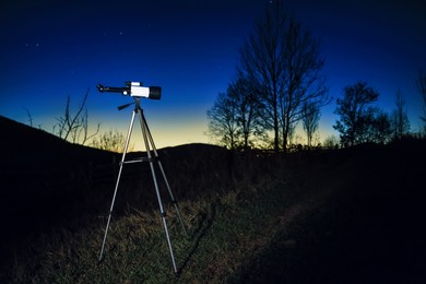 Photo of Modern telescope and beautiful sky in evening outdoors. Learning astronomy