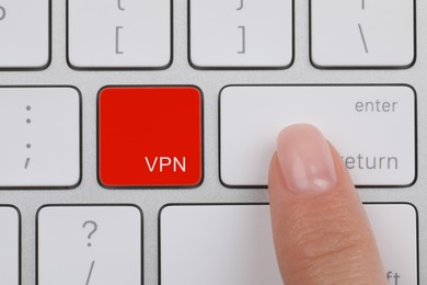 Image of VPN concept. Woman pressing button on computer keyboard, top view
