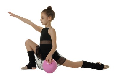 Cute little girl with ball doing gymnastic exercise on white background