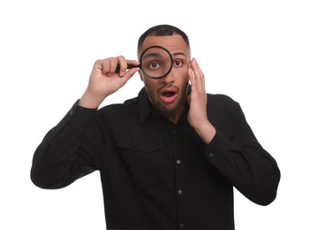 Photo of Shocked man looking through magnifier glass on white background
