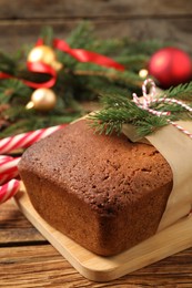 Photo of Delicious gingerbread cake and Christmas decor on wooden table