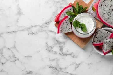 Tasty pitahaya smoothie, dragon fruits and fresh mint on white marble table, flat lay. Space for text