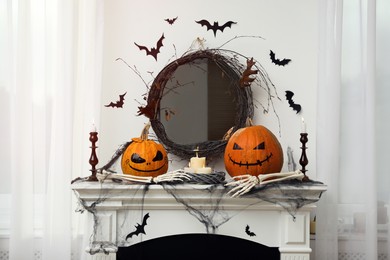 Different Halloween decor on mantelpiece indoors. Festive interior
