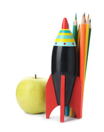 Bright modern toy rocket, pencils and apple isolated on white. Back to school