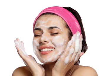 Beautiful woman applying facial cleansing foam on white background