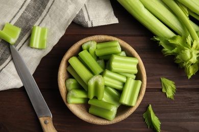 Photo of Fresh ripe green celery on wooden table, flat lay