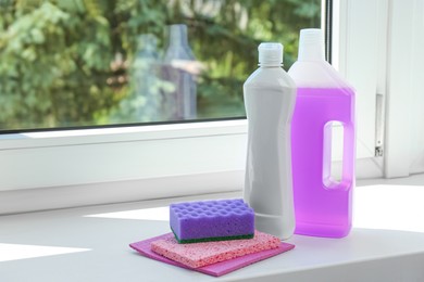 Photo of Cleaning supplies and tools on window sill indoors, space for text