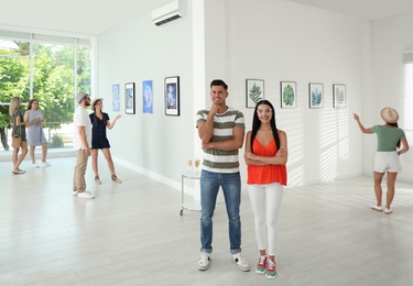 Happy couple at exhibition in art gallery