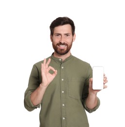 Happy man with phone showing okay gesture on white background