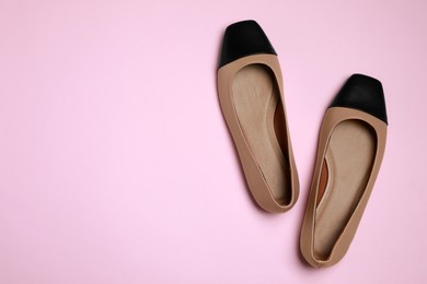 Photo of Pair of new stylish square toe ballet flats on pale pink background, flat lay. Space for text