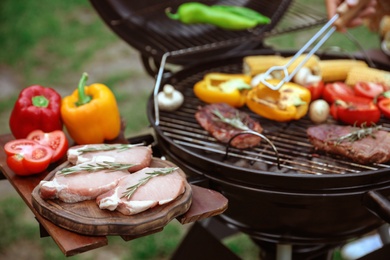 Modern barbecue grill with fresh products outdoors, closeup