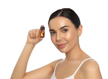 Young woman with bottle of essential oil on white background
