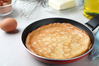 Delicious thin pancakes on grey marble table, closeup