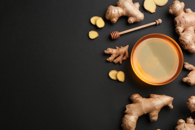 Photo of Ginger and honey on black table, flat lay with space for text. Natural cold remedies