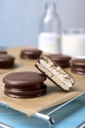 Tasty choco pies on parchment paper, closeup view