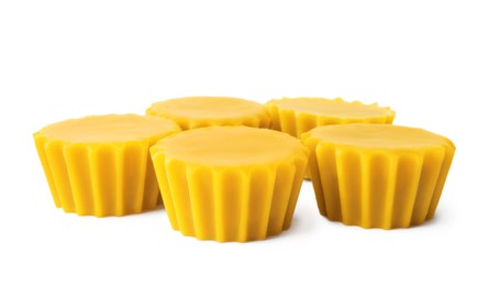 Photo of Natural beeswax cake blocks on white background