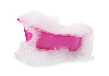 Pink toy bathtub with foam isolated on white