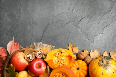 Flat lay composition with vegetables, fruits and autumn leaves on black slate table, space for text. Thanksgiving Day