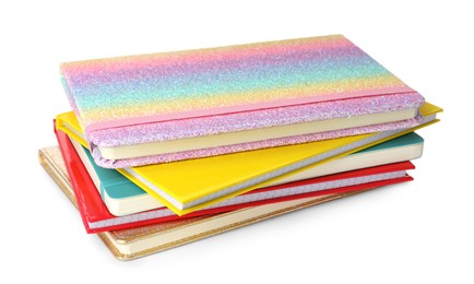 Stack of different colorful hardcover planners on white background