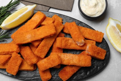 Tasty fresh fish fingers served on white table, flat lay