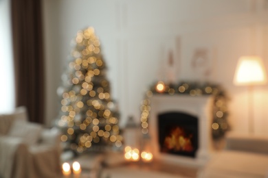 Blurred view of fireplace in living room decorated for Christmas