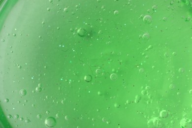 Photo of Closeup view of green slime as background. Antistress toy