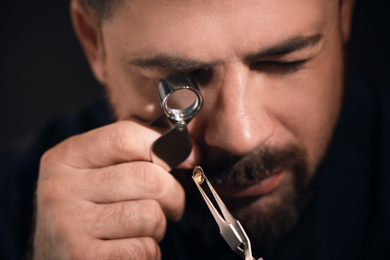 Professional jeweler working with gemstone, closeup view
