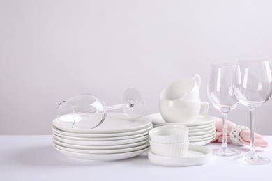 Set of clean dishes on white table