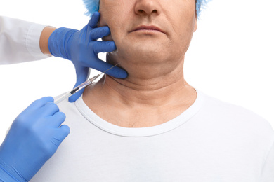Mature man with double chin receiving injection on white background, closeup