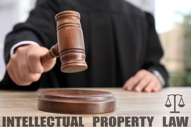 Intellectual property law. Judge with gavel at table, closeup