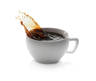 Coffee splashing out of cup on white background