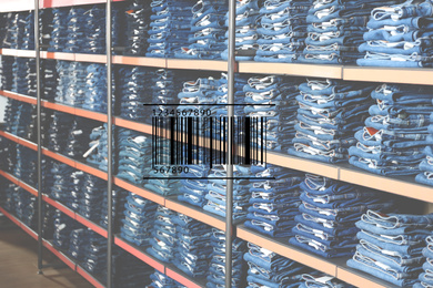 Barcode and collection of stylish jeans on shelves in wholesale shop