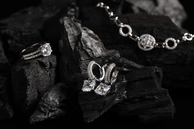 Photo of Stylish presentation of elegant jewelry on coal