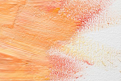 Beautiful strokes of colorful oil paints on white canvas, closeup