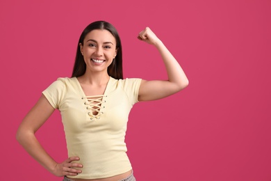 Strong woman as symbol of girl power on pink background, space for text. 8 March concept