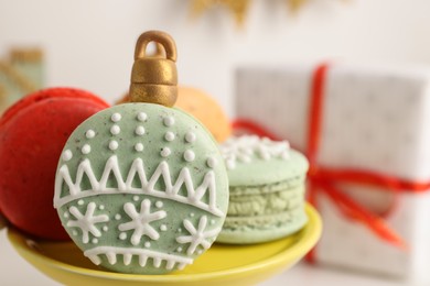 Photo of Beautifully decorated Christmas macarons on stand, closeup. Space for text