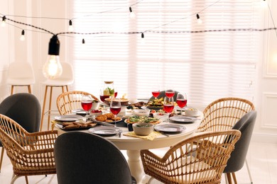 Brunch table setting with different delicious food and chairs indoors