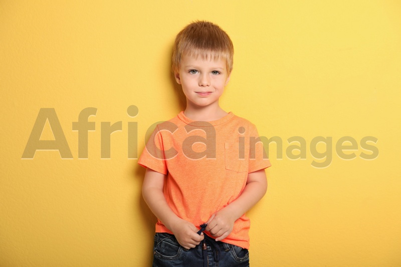 Portrait of cute little boy against color background