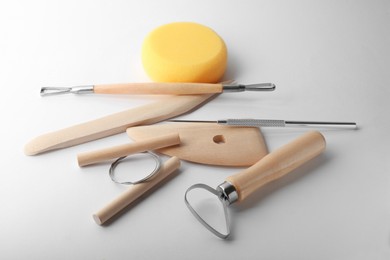 Photo of Set of clay modeling tools on white background