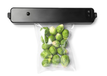 Sealer for vacuum packing and plastic bag with Brussels sprouts on white background, top view