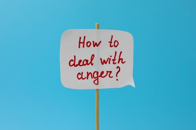 Paper speech bubble with inscription How To Deal With Anger? on light blue background