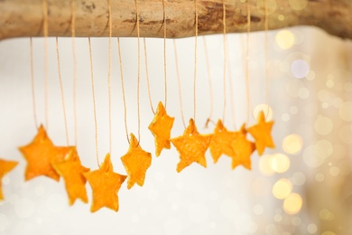 Photo of Stars made of tangerine peel hanging against blurred background