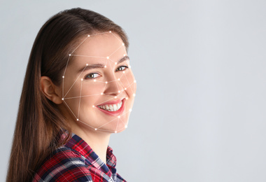 Facial recognition system. Young woman with biometric identification scanning grid on light background, space for text