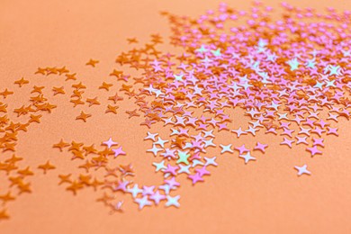 Photo of Shiny bright glitter on light pink background
