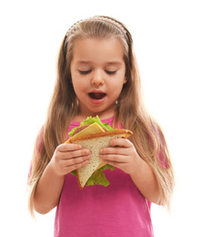 Photo of Cute little girl eating tasty sandwich on white background