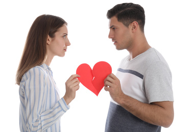 Couple tearing paper heart on white background. Relationship problems