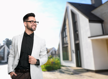 Real estate agent against modern house. Space for text