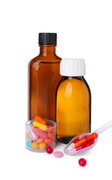 Photo of Bottles of syrups, measuring cup, plastic spoon with pills on white background. Cough and cold medicine