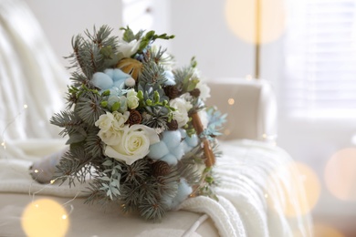 Beautiful wedding winter bouquet on sofa indoors, space for text. Bokeh effect