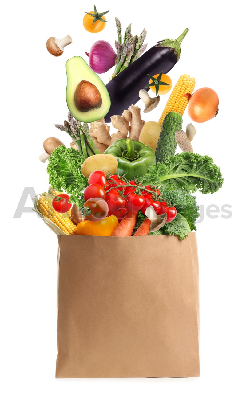 Image of Paper bag with vegetables on white background. Vegetarian food 